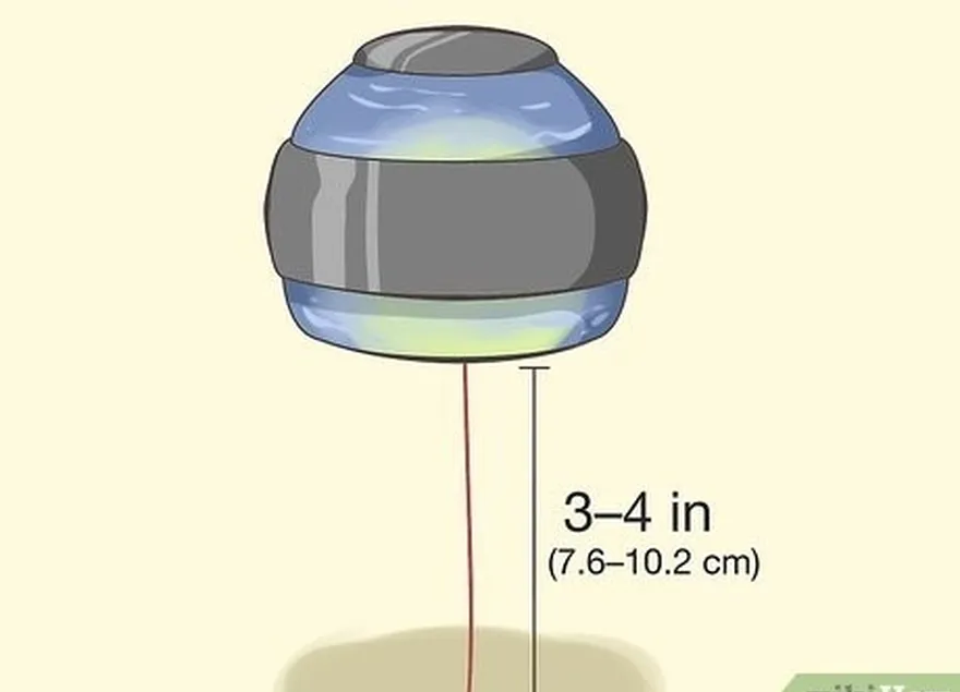 adım 6 3-4 inç (7,6-10,2 cm) kordonunuz kaldığında topu yukarı sarmayı bırakın.